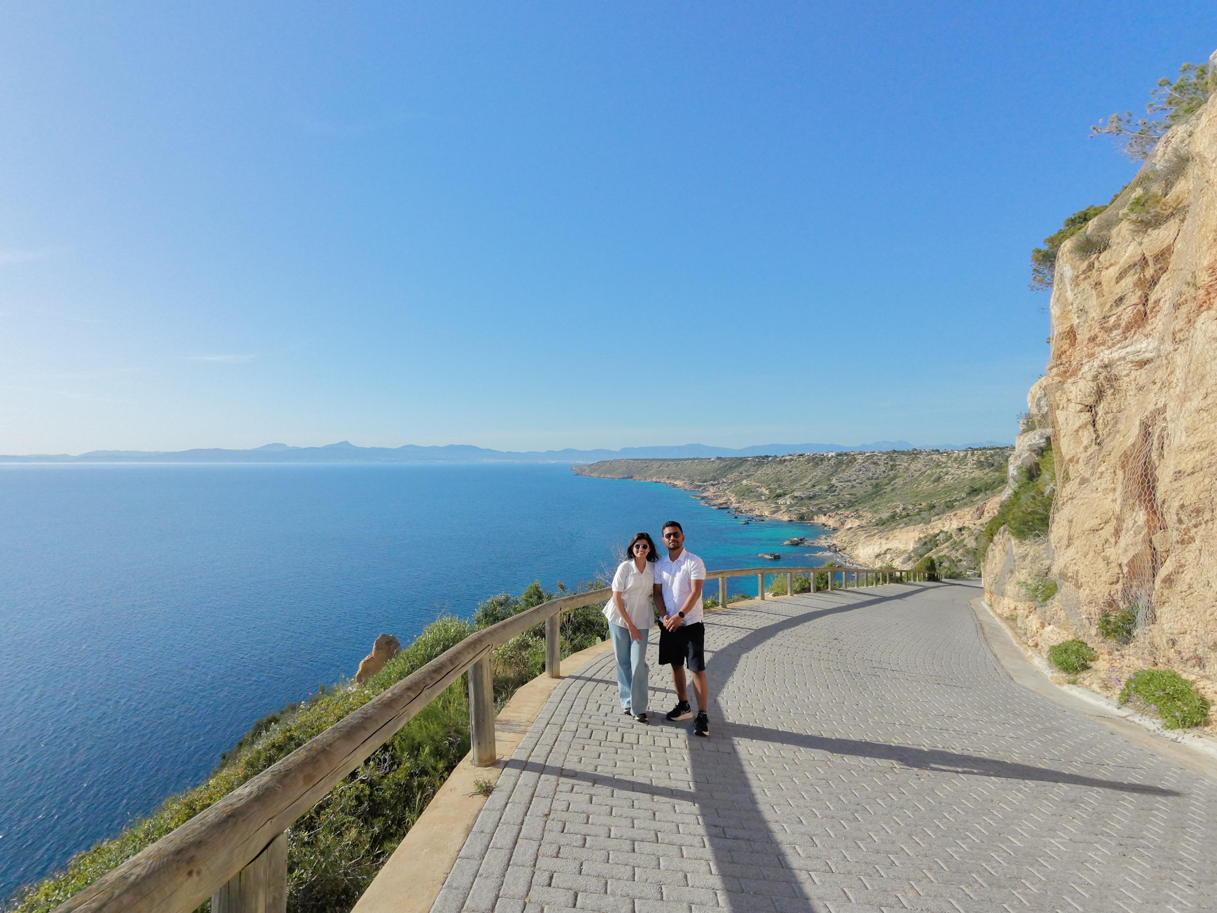 The Two Miles, standing on a cliffside path above the sea
